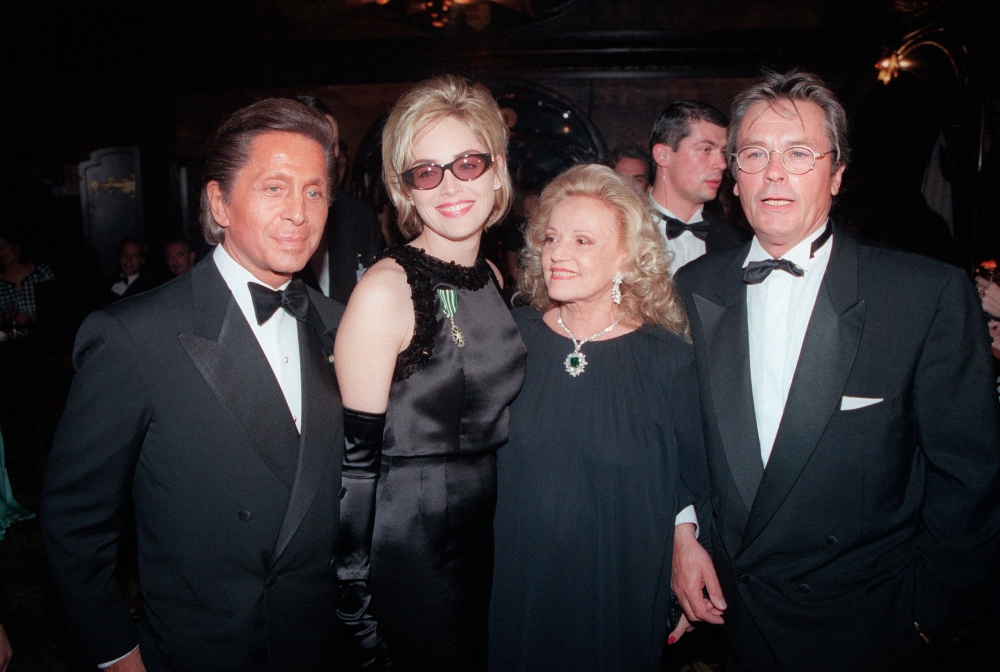 Italian fashion designer Valentino, US actress Sharon Stone pose on October 25, 1995 in Paris with French actors Jeanne Moreau and Alain Delon during a party organized by Valentino in Maxim's restaurant. — AFP file pic 