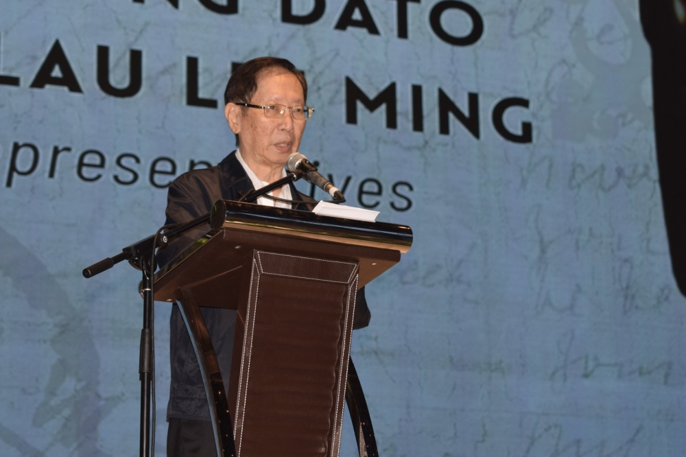 Datuk Vincent Lau delivers his speech during the 20th Memorial Anniversary of the late Datuk Seri Lau Hui Kang held at KTS Garden here on Monday. — The Borneo Post pic