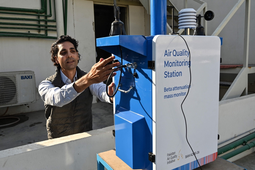 Abid Omar, an engineer, explains the air-quality monitoring station installed on a rooftop of his office in Karachi January 9, 2026. — AFP pic