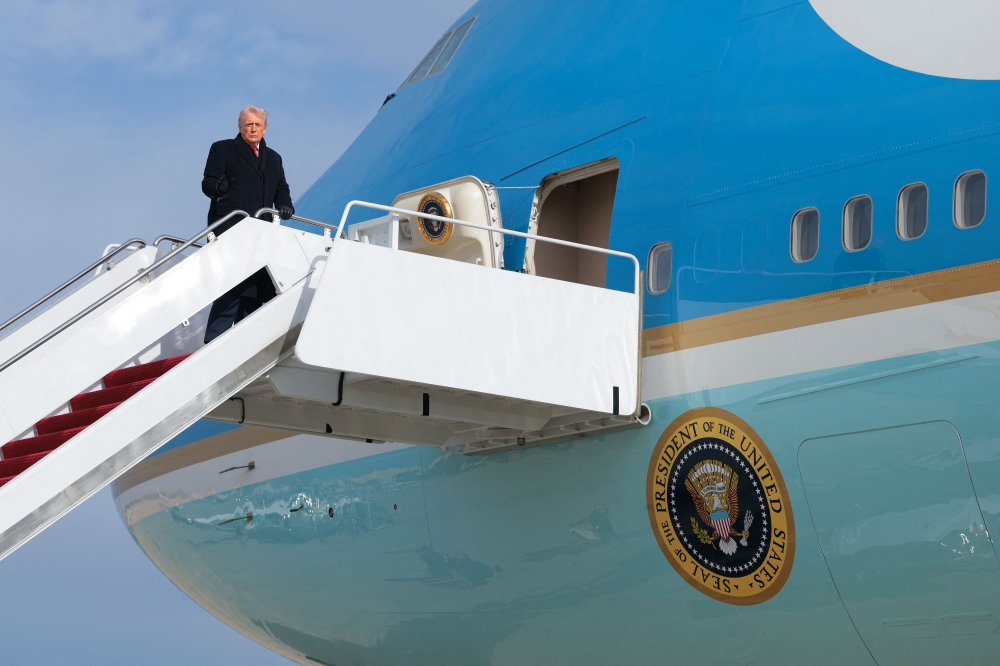 President Trump prepares to board a second Air Force One after a midair electrical glitch forced the plane to U-turn back to the US on January 20, 2026. — Getty Images via AFP 