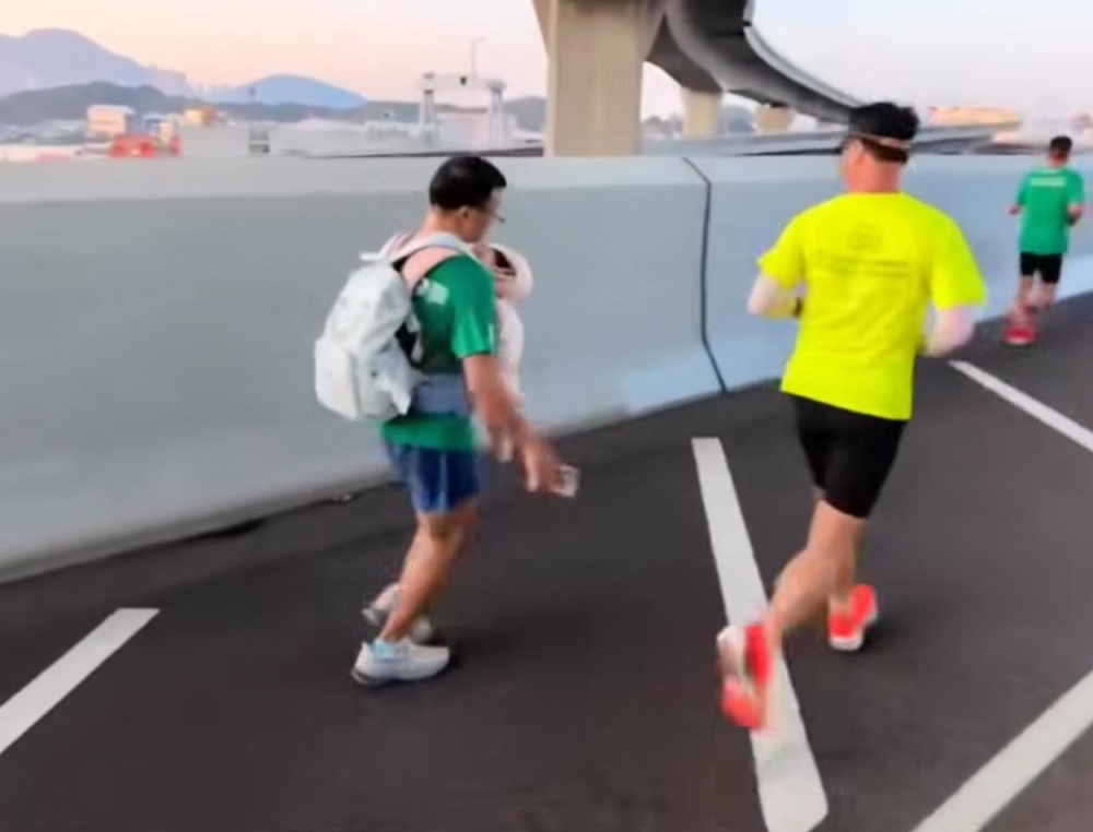 Police question runner after baby-carrying stunt at Hong Kong Marathon