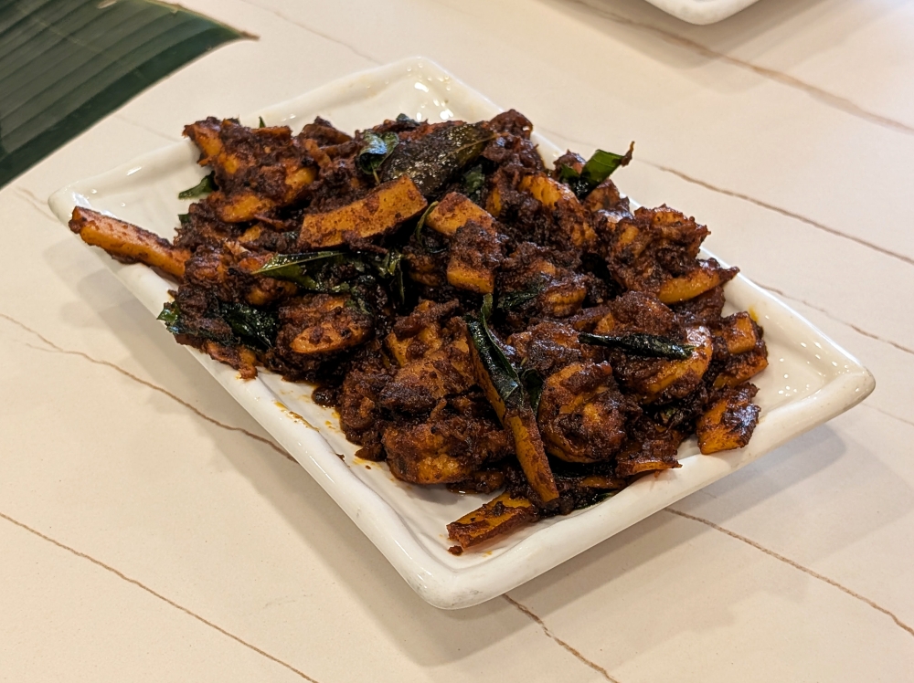 Stir-fried prawns with strips of coconut in a thick ‘masala’ paste.