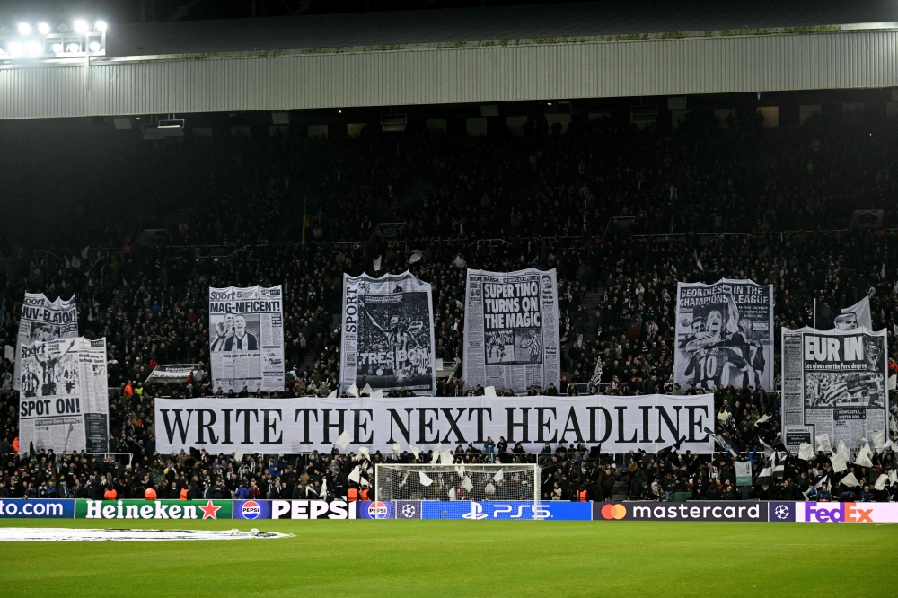 Newcastle United fans display a tifo inspired by newspaper pages before the Champions League match against PSV Eindhoven at St James’ Park in Newcastle-upon-Tyne on January 21, 2026. — AFP pic