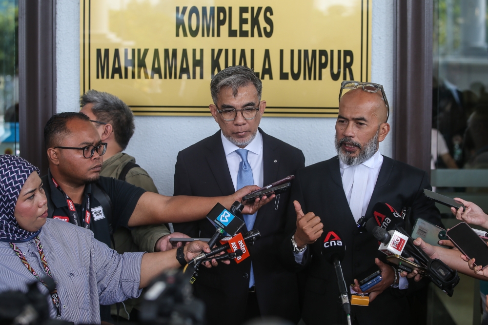 (From left to right) Lawyer Fahmi Moin, who represents the ex-Army chief's wife Salwani Anuar @ Kamaruddin and lawyer Aizul Rohan Anuar who represents former Army chief Tan Sri Muhammad Hafizuddeain Jantan speaks to reporters at the Kuala Lumpur High Court Complex on January 22, 2026. — Picture by Yusof Isa