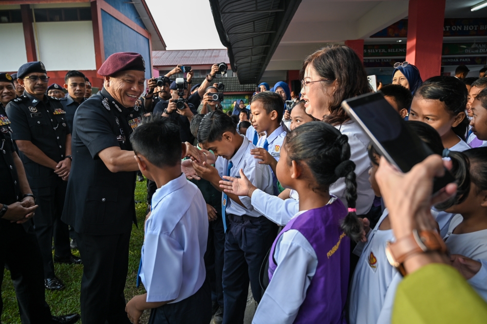 Inspector-General of Police Datuk Seri Mohd Khalid Ismail greets students at the Back to School Programme at Sekolah Kebangsaan Bidor in Bidor January 22, 2026. — Bernama pic