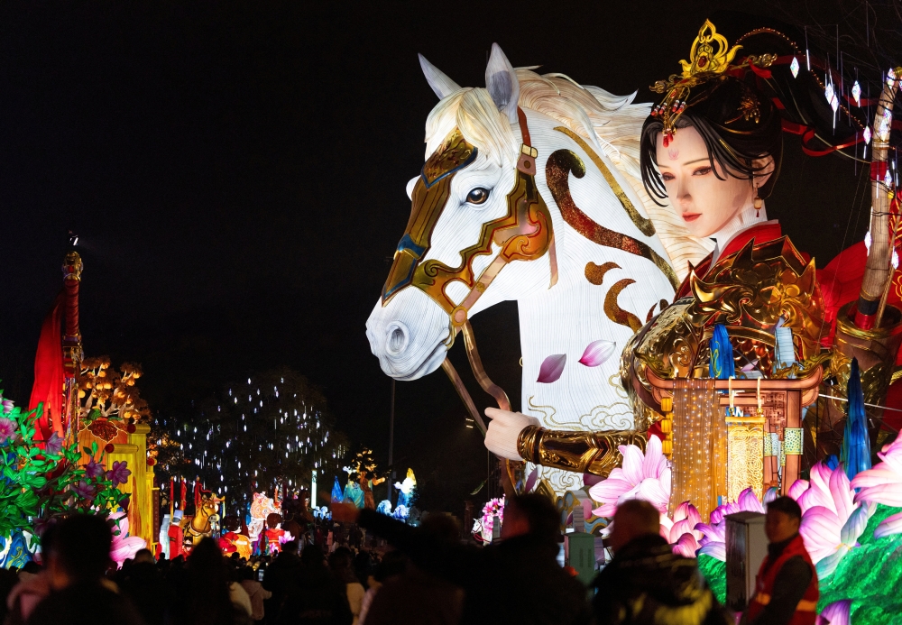 People walk next to the “Legend of Mulan” light installation at the 32nd Zigong International Lantern Festival in Zigong, Sichuan province, China on January 23, 2026. — Reuters pic