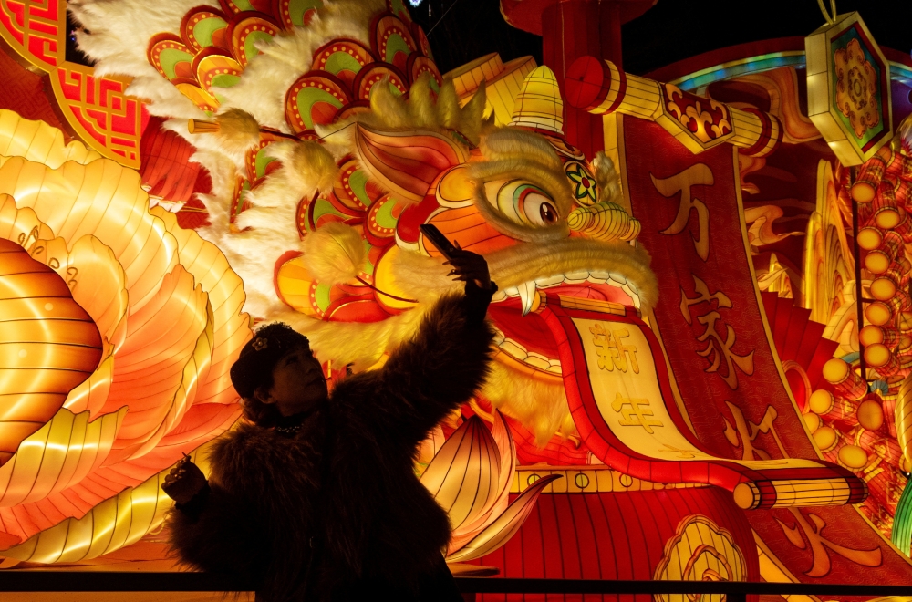 A woman takes a selfie next to a light installation at the 32nd Zigong International Lantern Festival in Zigong, Sichuan province, China on January 23, 2026. — Reuters pic