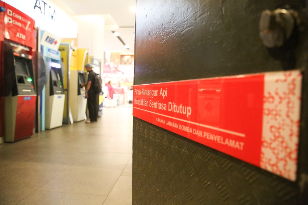 Fire-rated doors are easily identified by red advisory signs instructing that they remain closed at all times.— Picture by Choo Choy May