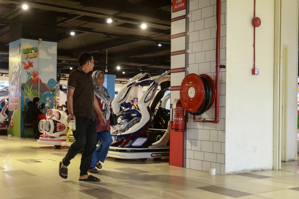 Hose reels are either stored in a wall-mounted casing or as freestanding equipment, and are usually painted red to enhance visibility. — Picture by Sayuti Zainudin