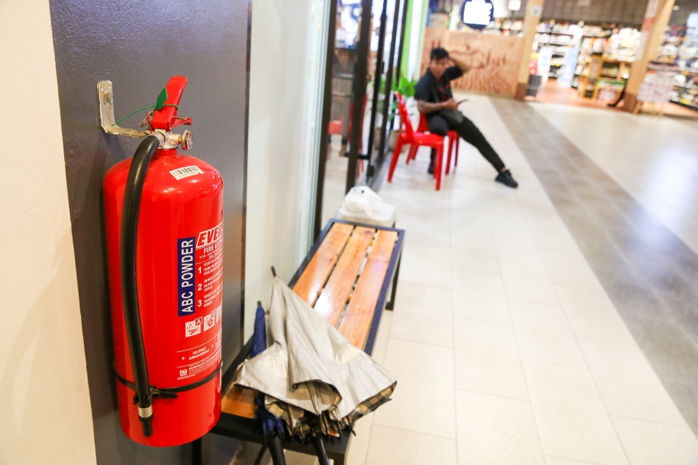 Like the hose reel, portable fire extinguishers are either stored in a wall-mounted casing or as freestanding equipment. — Picture by Choo Choy May
