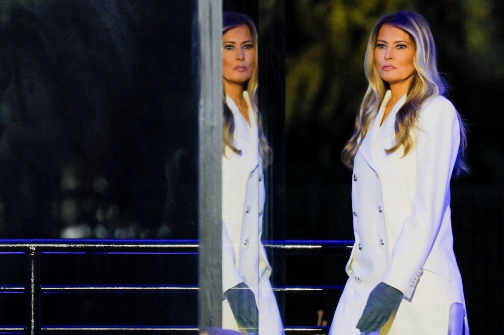 This file picture shows US first lady Melania Trump is reflected on bulletproof glass as she appears on stage during the National Christmas Tree lighting ceremony at the White House in Washington, D.C., US, December 4, 2025. — Reuters pic