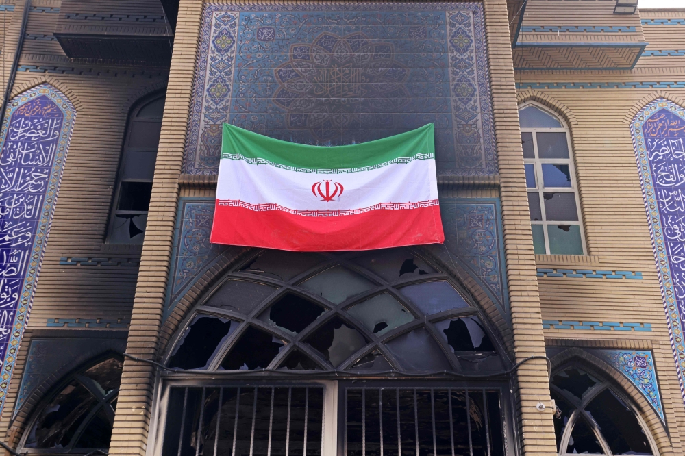 The Iranian national flag installed on the Beheshti Mosque that was damaged during recent public protests, in Tehran on January 21, 2026. Limited internet access briefly returned in Iran before dropping again amid a communications blackout that rights groups said aimed to mask a protest crackdown that killed thousands. — AFP pic