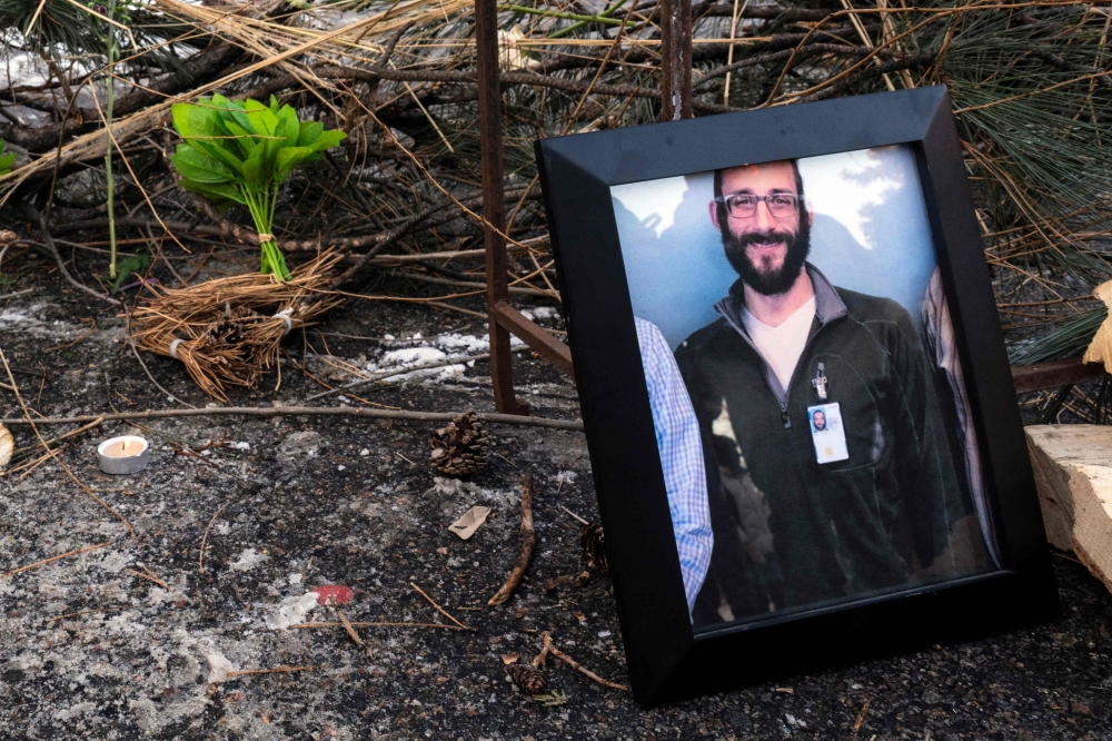 A photograph of 37-year-old Alex Pretti can be seen at a makeshift memorial in the area where he was shot dead by federal immigration agents earlier in the day in Minneapolis, Minnesota, on January 24, 2026. — AFP pic