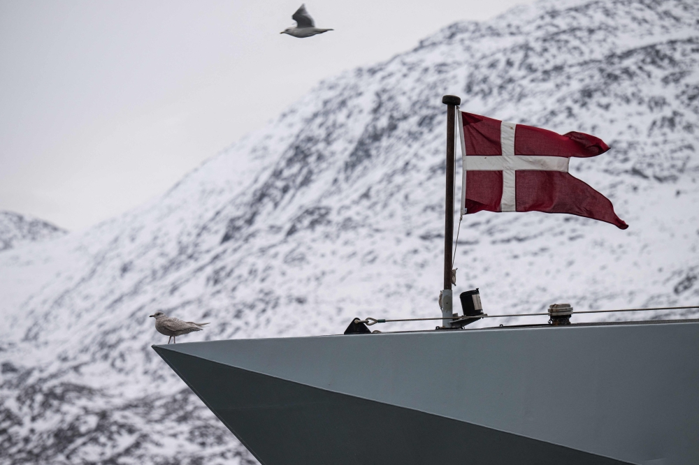 This photograph shows the Danish flag fying on the HDMS Knud Rasmussen (P570), a Royal Danish Navy offshore patrol vessel, as it is moored in Nuuk harbour, Greenland, on January 24, 2026. — AFP pic