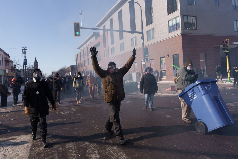 Demonstrators chant and walk towards law enforcement as they depart the site where a man identified as Alex Pretti was fatally shot by US federal agents. — AFP pic
