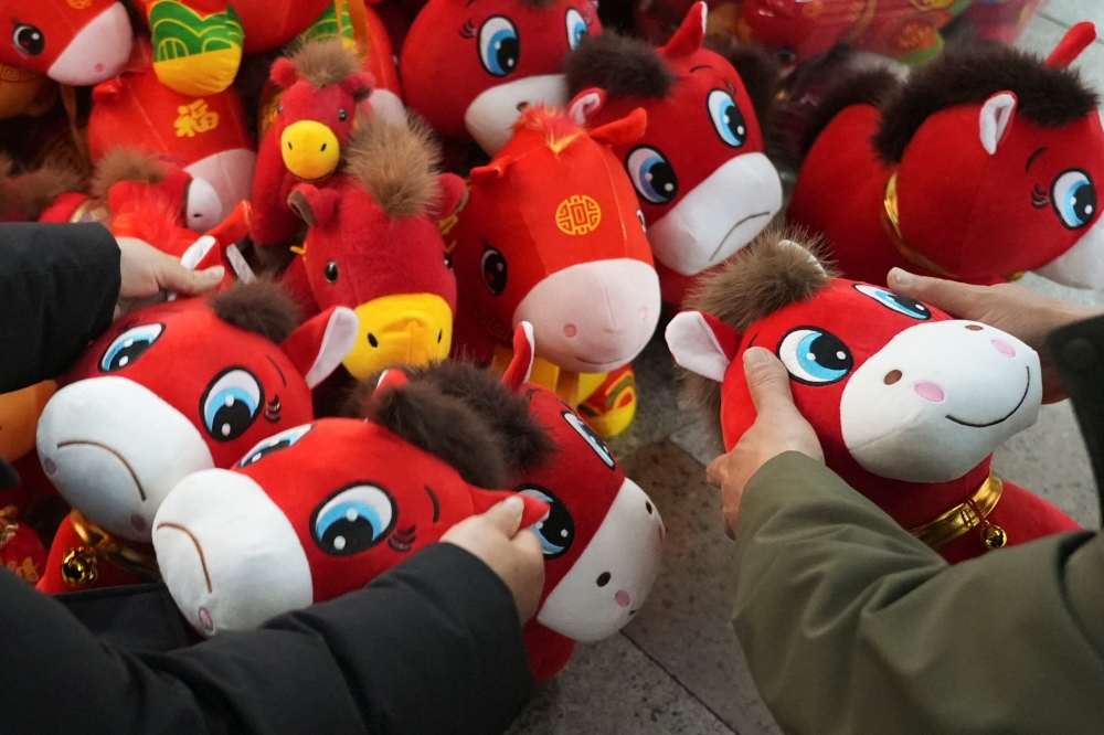 Customers look at crying horse and smiling horse plush toys ahead of the Chinese Lunar New Year, which will welcome the Year of the Horse, at Yiwu International Trade City in Yiwu, Zhejiang province January 21, 2026. — Reuters pic 