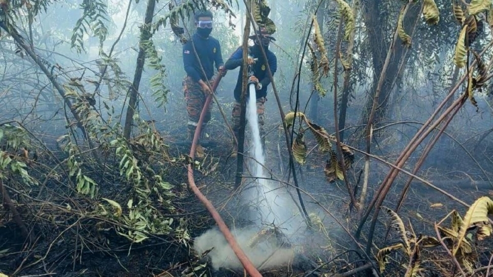 Johor firefighters battle to curb a peat fire in Taman Bayu Damai that has already forced two families to evacuate on January 26, 2026. — Picture from Facebook/Komuniti Johor