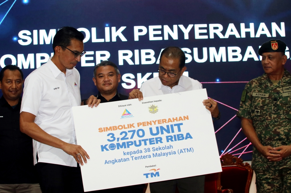 Defence Minister Datuk Seri Mohamed Khaled Nordin receives a souvenir during a working visit to Kem Terendak in Sungai Udang on January 26, 2025. — Bernama pic