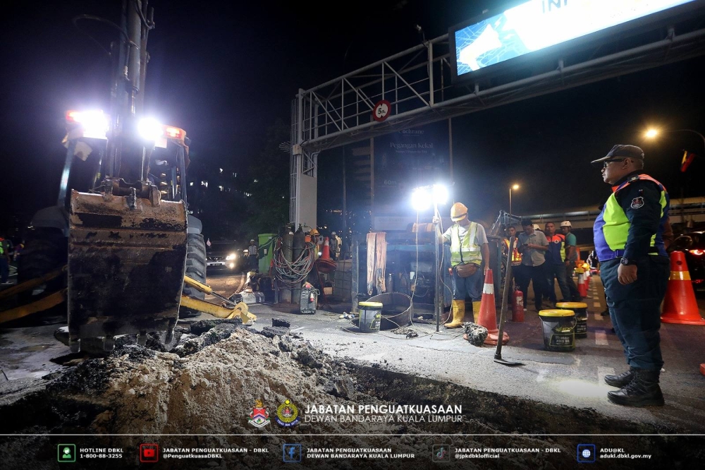 DBKL enforcers inspect a road excavation site in Kuala Lumpur. — DBKL pic