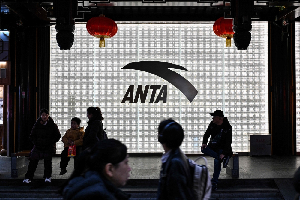 People walk past an Anta store in the Huangpu district of Shanghai on January 27, 2026. — AFP pic 