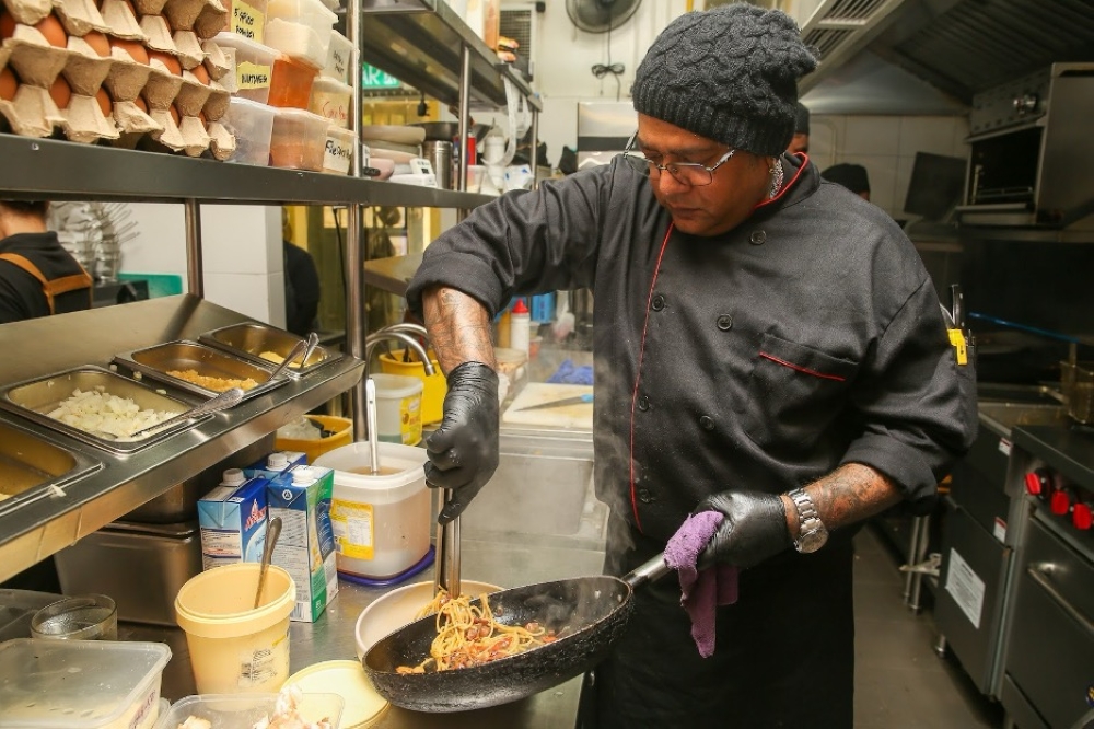 A team of culinary experts are on hand to cook up various dishes like their popular Bacon Aglio Olio Pasta. — Picture by Choo Choy May