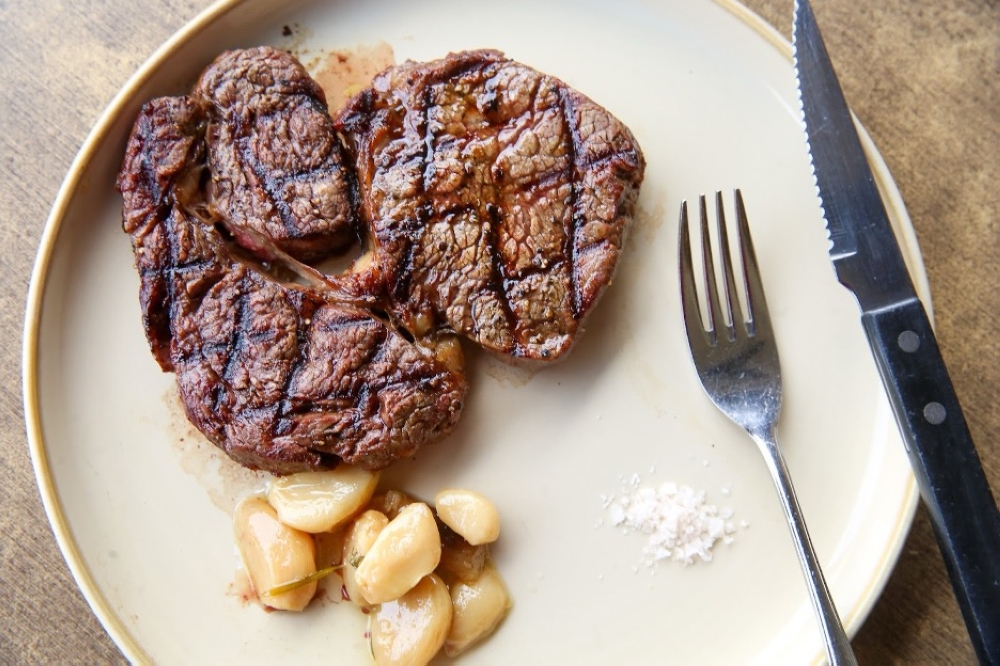 Carnivores love the selection of meats that include Grilled MB2 Grass Fed Ribeye served with roasted garlic and salt. — Picture by Choo Choy May