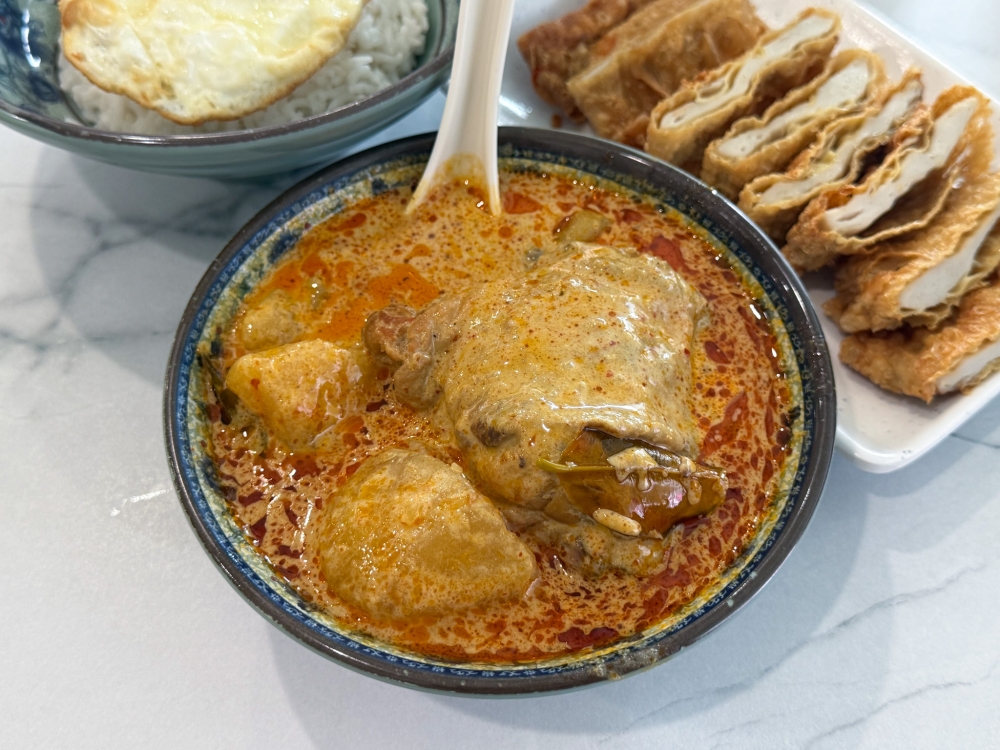 Dry Chicken Curry is generous with smooth chicken, chunky potatoes paired with a mild, creamy curry. — Picture by Lee Khang Yi