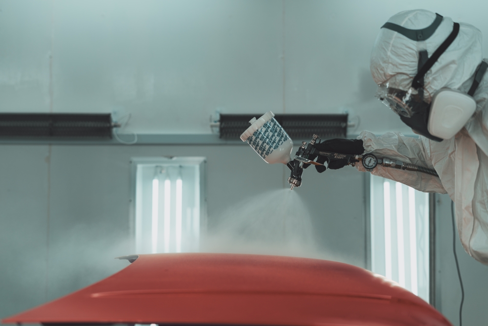 A technician applies SPPF’s spray-on paint protection system to a vehicle inside a controlled spray booth. — Picture courtesy of SPPF