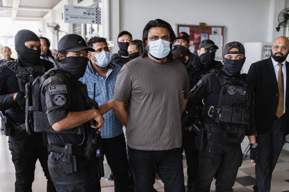 One of the three suspects linked to the ‘Captain Praba’ organised crime group under police escort at the Sepang Court Complex to face charges at the Sessions Court on January 28, 2026. — Picture from Facebook/Bernama
