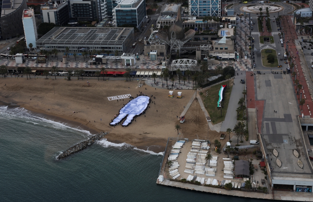Giant portrait of Hind Rajab unfurled on Barcelona beach as her mother urges world to free Gaza’s children