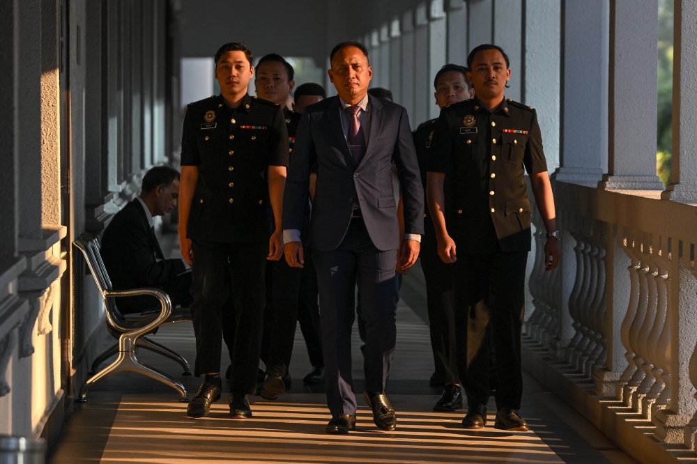 Major-General Datuk Mohamed Fauzi Kamis (centre), 56, pled not guilty to criminal breach of trust involving RM5 million from the Armed Forces Welfare Fund at the Sessions Court in Kuala Lumpur on January 30, 2026. — Bernama pic