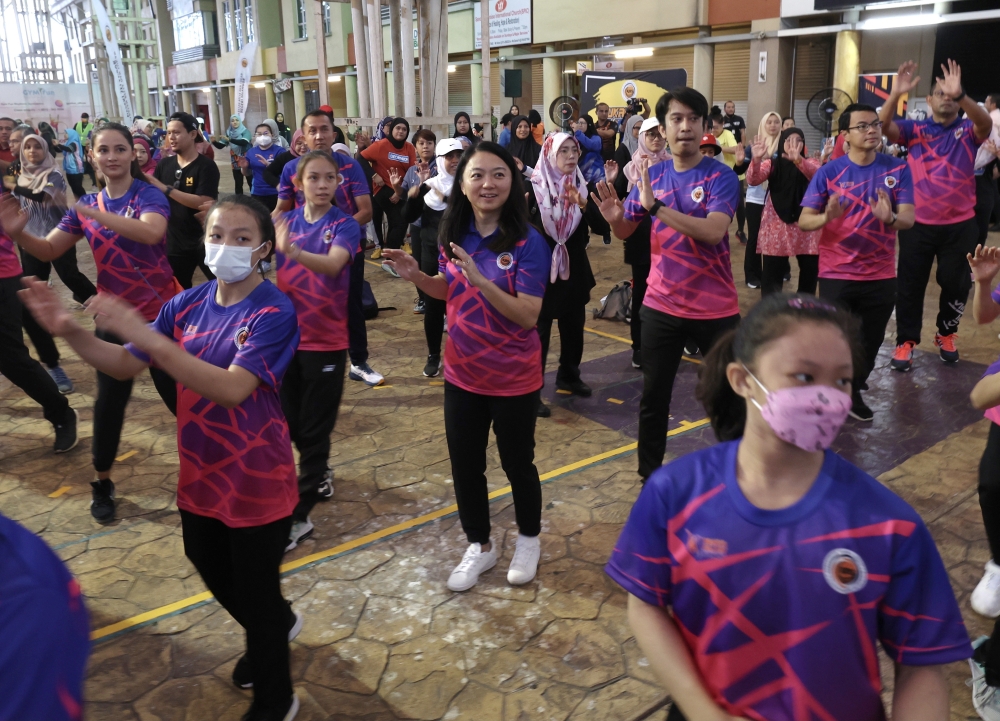 People participate in an aerobic exercise programme. Federal Territories Minister Hannah Yeoh (centre) is planning free weekly exercises for children, starting with Putrajaya, to reduce child obesity rates. — Bernama file pic