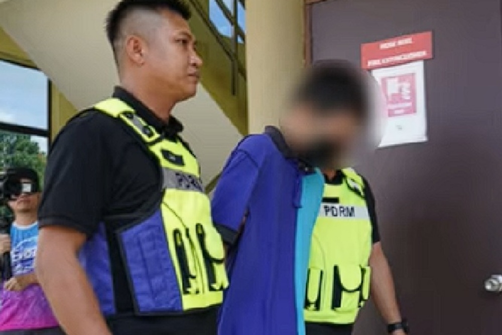 The accused being escorted by police personnel at the Sri Aman Sessions Court. — The Borneo Post pic
