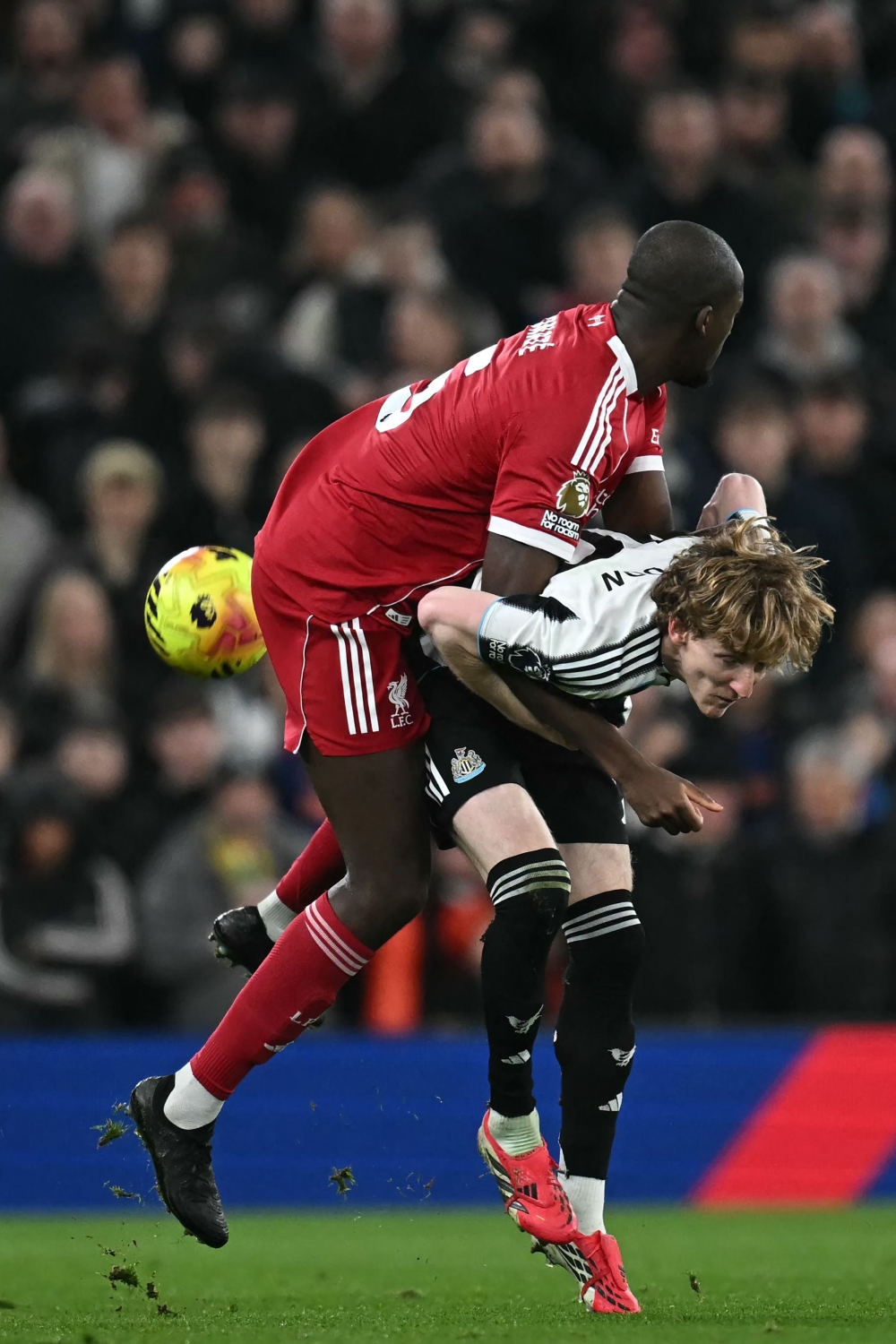Liverpool’s French defender Ibrahima Konate challenges Newcastle United’s English midfielder Anthony Gordon during their Premier League clash at Anfield, Liverpool, yesterday. — AFP pic