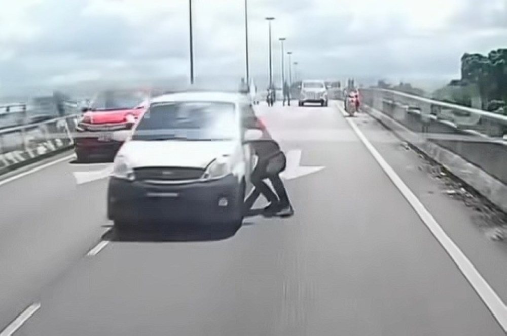 A screengrab from a viral video on social media shows police personnel attempting to halt and apprehend the suspect. — Picture via Facebook/James Boon
