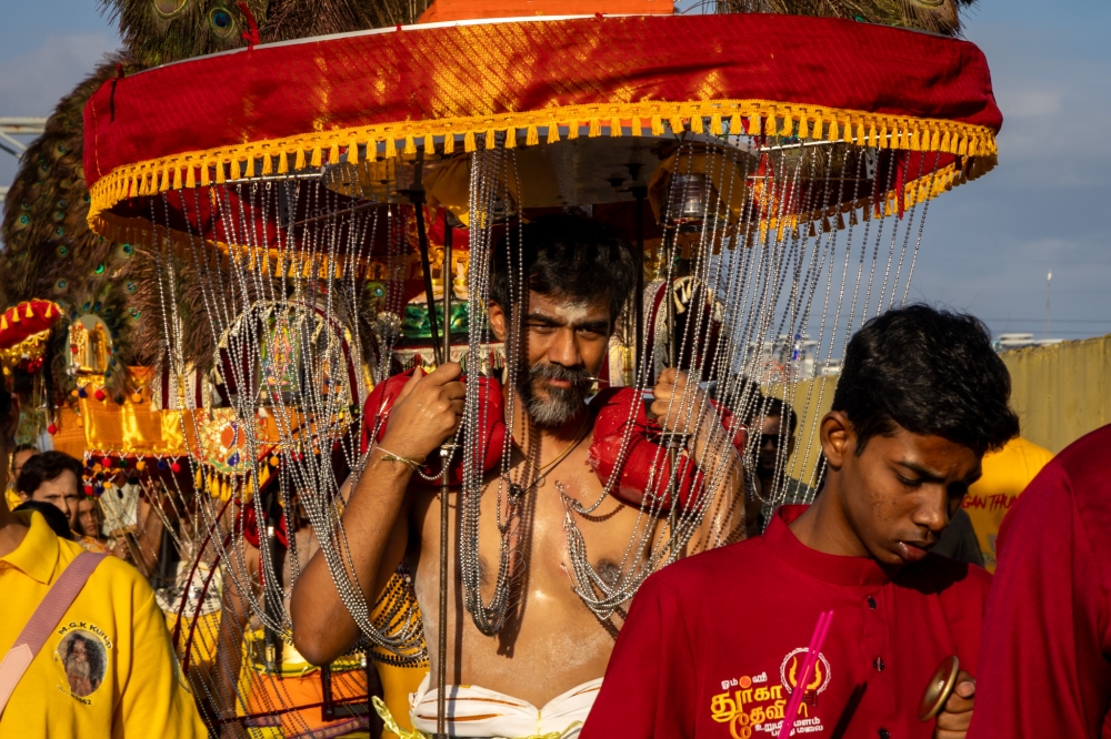 Hindu devotees carry kavadi on their shoulders towards Batu Caves temple during Thaipusam, February 1, 2026. — Picture by Firdaus Latif