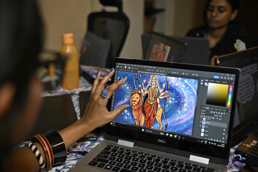 Graphic designers of India’s oldest and indigenous comic book publisher Amar Chitra Katha, illustrate on laptops at their office in Bengaluru. — AFP pic