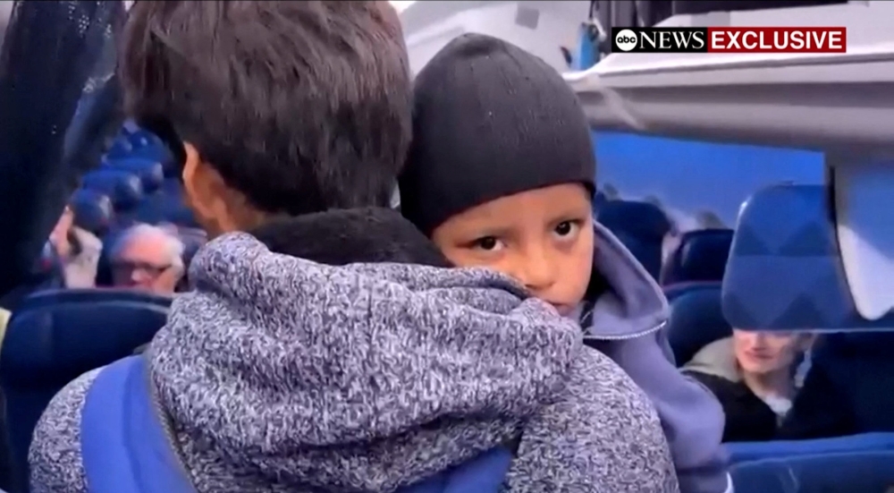 Liam Conejo Ramos is held by his father Adrian Alexander Conejo Arias while boarding an aircraft to return to Minneapolis, after the pair who had been detained by immigration officers were ordered released by a judge from a Texas detention centre, in San Antonio, Texas, February 1, 2026 in a still image from video. — ABC News via Reuters