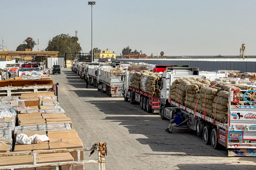 Trucks transporting humanitarian aid wait to enter through the Egyptian side of the Rafah border crossing with the Gaza Strip in northeastern Egypt on January 27, 2026, as the vital crossing to the Palestinian territory reopens. — AFP pic 