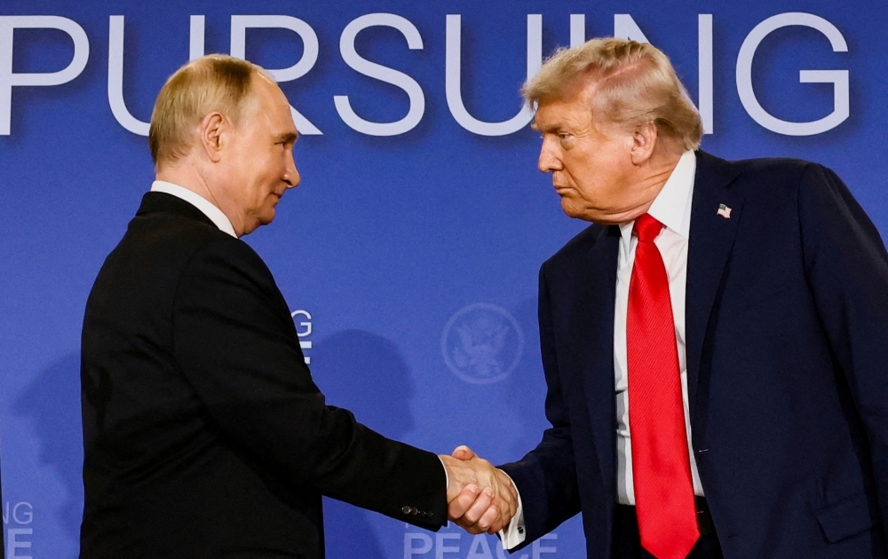 US President Donald Trump and Russian President Vladimir Putin shake hands during a press conference following their meeting to negotiate an end to the war in Ukraine, at Joint Base Elmendorf-Richardson, in Anchorage, Alaska August 15, 2025. — Reuters pic