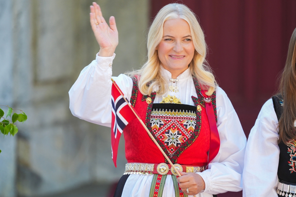 Norway's Crown Princess Mette-Marit greets the children's parade during the May 17 celebrations at the Royal residence, Skaugum, west of the Norwegian capital Oslo, on May 17, 2024. — serud/NTB/AFP pic