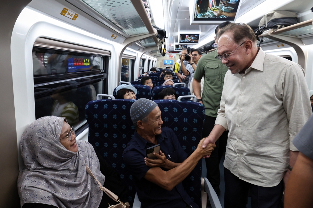 Prime Minister Datuk Seri Anwar Ibrahim greets passengers at JB Sentral before departing on the ETS following a family visit to Johor in Johor Bahru on February 2, 2026. — Bernama pic