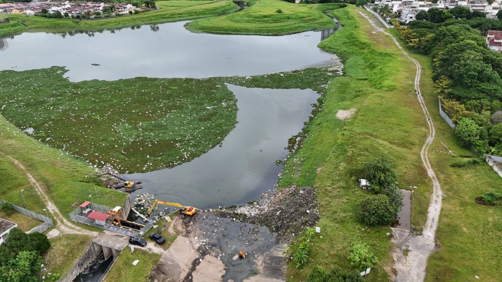 The Jinjang flood retention pond undergoing cleaning operations following an earlier downpour. — Picture courtesy of PLSK