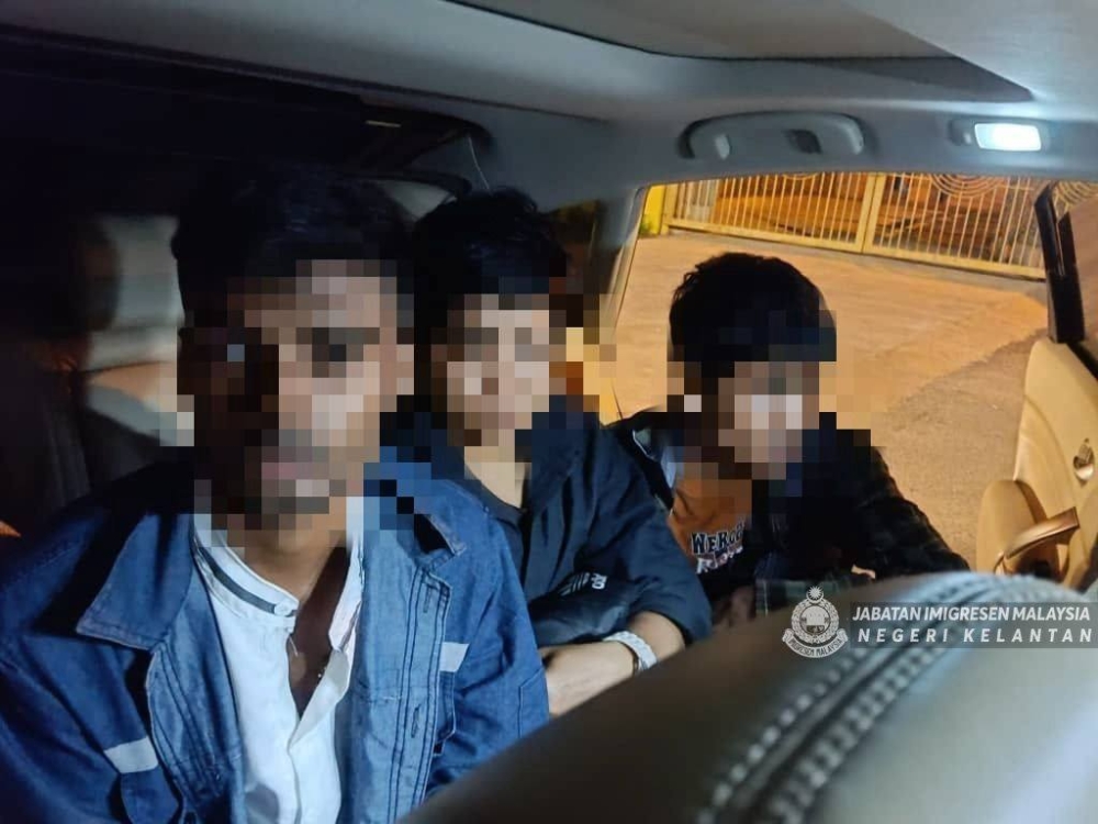 The Kelantan Immigration Department arrested two local men and five illegal immigrants in a crackdown on a migrant smuggling syndicate, carried out under Ops Serkap around Kota Bharu on Sunday and yesterday. — Picture via Facebook/JIM Kelantan