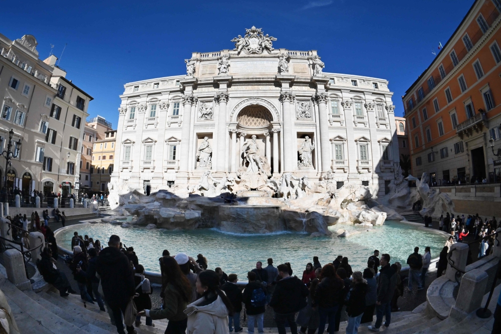 A general view shows tourists visiting the Trevi Fountain in Rome, after the city introduces a €2 paid entry, in Rome on February 2, 2026. A new ticketing system goes into effect for the first time at the Trevi Fountain, one of Rome's most famous monuments and the latest tourist attraction to require admission in an effort to control crowds. — AFP pic