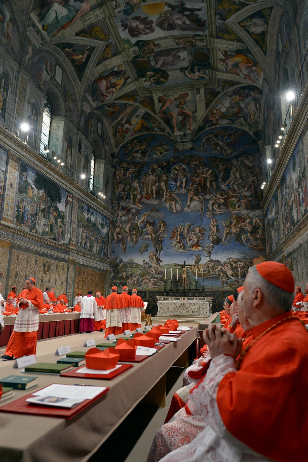 Cardinals sit in the Sistine Chapel — which has Michelangelo’s soaring Last Judgment on one wall — to begin the conclave in order to elect a successor to Pope Benedict at the Vatican March 12, 2013. — Osservatore Romano/Reuters pic