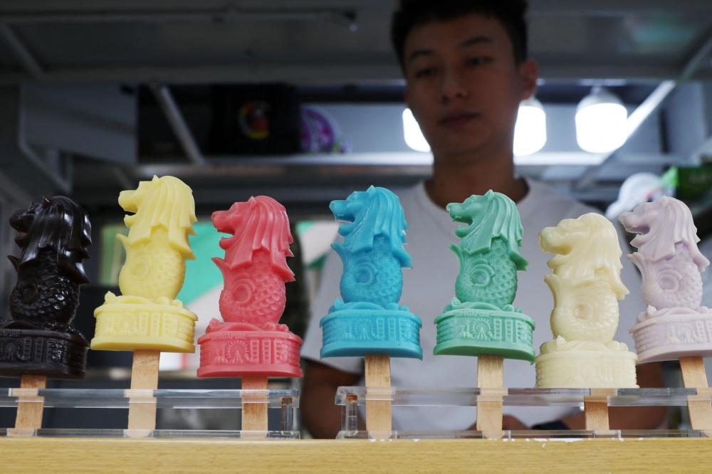 A shopkeeper sells Merlion ice-cream popsicles at Chinatown in Singapore. STB said tourism receipts rose 6.5 per cent year-on-year between January and September, putting the country ‘on track to exceed’ its full-year projection of between S$29 billion and S$30.5 billion. — Reuters pic
