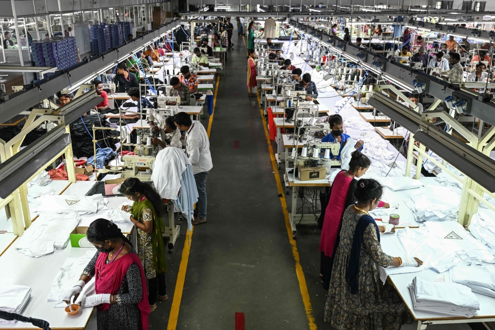 In this photograph taken on September 23, 2025, employees work at a garment factory in Tiruppur, in India's southern state of Tamil Nadu. Consumer goods like textiles, jewellery and auto parts were hit the hardest by US tariffs. — AFP pic 