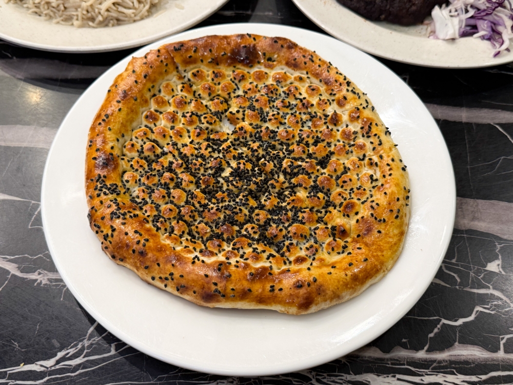 Black Seeds Naan is golden brown flatbread with the unmistakable aroma of sesame seeds. 