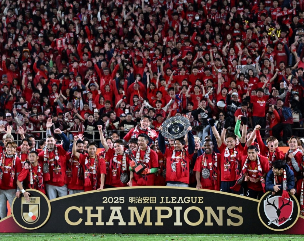 Kashima Antlers players and supporters celebrate their victory after winning a J1 League match against Yokohama F. Marinos in the final game of the season at Mercari Stadium in Kashima City, Ibaraki Prefecture, Japan, December 6, 2025. — AFP pic
